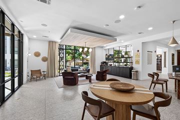 San Antonio apartment for rent - A modern living room with a large wooden table and chairs.
