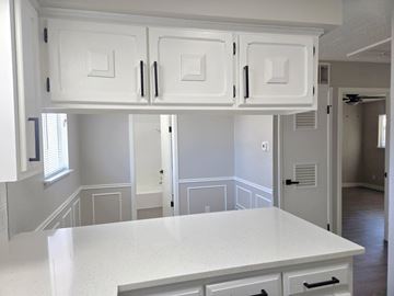 Austin apartment for rent - A kitchen with white cabinets and a white countertop.
