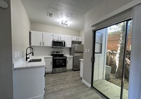 Austin apartment for rent - A kitchen with white cabinets and appliances.