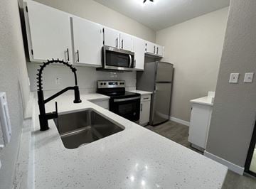 Austin apartment for rent - A kitchen with a sink and a microwave.