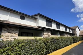 Austin apartment for rent - A building with a stone facade and a yellow line in front of it.