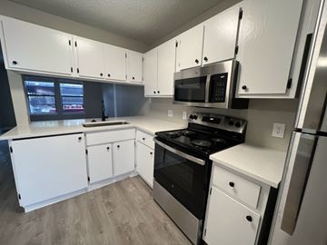 Austin apartment for rent - A kitchen with white cabinets and appliances.