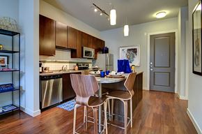 San Antonio apartment for rent - A kitchen with a table and chairs in the middle.