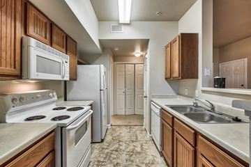 Austin apartment for rent - A kitchen with a stove top oven and microwave above it.