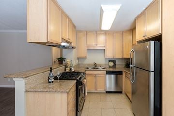 Escondido apartment for rent - A kitchen with wooden cabinets and a granite counter top.