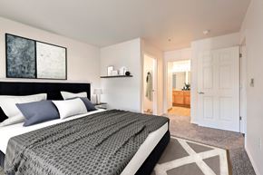 Renton apartment for rent - A bedroom with a large bed and a painting on the wall.