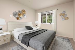 Mill Creek apartment for rent - A bedroom with a large bed and two wall decorations.
