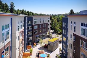 Kirkland apartment for rent - A view of a courtyard with a green roof and a pool surrounded by buildings. at Kirkland Crossing Apartments, Washington, 98033
