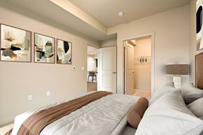 Kirkland apartment for rent - A bedroom with a large bed and a painting on the wall.