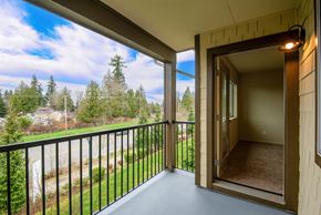 Mill Creek apartment for rent - A balcony with a view of a road and trees.