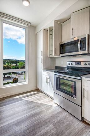 Redmond apartment for rent - A modern kitchen with a stainless steel oven and microwave. at Ravello Apartments, Redmond