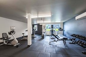 Kirkland apartment for rent - A gym with a variety of equipment including treadmills, weights, and exercise machines. at Kirkland Crossing Apartments, Kirkland, WA