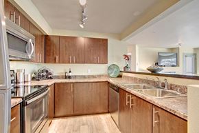 Mill Creek apartment for rent - A kitchen with wooden cabinets and a granite countertop. at Mill Creek Meadows Apartments, Washington, 98012