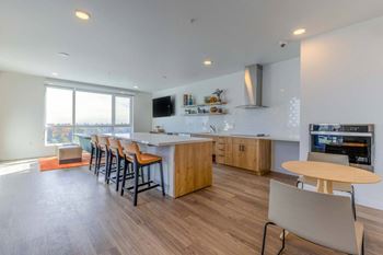 A modern kitchen with wooden floors and a large island.