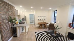 Brooklyn apartment for rent - A living room with a brick wall and a black and white rug.