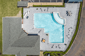 Tunica Resorts apartment for rent - An aerial view of a swimming pool surrounded by a concrete patio and a grassy area.