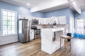 Horn Lake apartment for rent - A kitchen with a white island and stainless steel appliances.