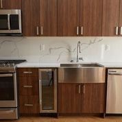 Brooklyn apartment for rent - A kitchen with wooden cabinets and stainless steel appliances.