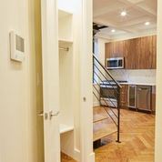 Brooklyn apartment for rent - A white door is open to a kitchen and staircase.
