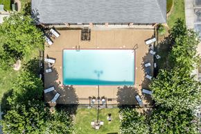 Horn Lake apartment for rent - An aerial view of a swimming pool surrounded by trees and a building.