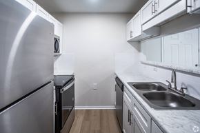 Tunica Resorts apartment for rent - A kitchen with a stainless steel refrigerator and a marble countertop.