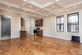 Brooklyn apartment for rent - A spacious room with wooden flooring and a ceiling with recessed lighting.