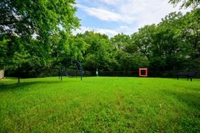 Hendersonville apartment for rent - A playground with a swing set and a red square in the distance.
