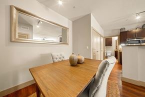 New Braunfels apartment for rent - A dining room with a wooden table and a large mirror above it.