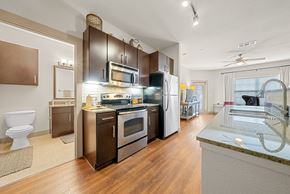 New Braunfels apartment for rent - A modern kitchen with dark wood cabinets and stainless steel appliances.