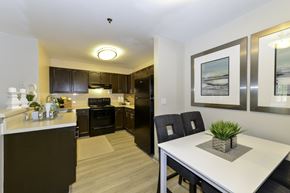 Dawsonville apartment for rent - A modern kitchen with a dining table and chairs.