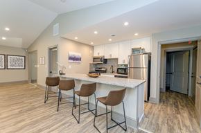 Marietta apartment for rent - A kitchen with a white countertop and brown chairs.