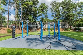 Marietta apartment for rent - A playground with a blue swing set and a green lawn.