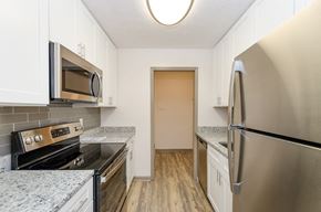 Marietta apartment for rent - A kitchen with a stove, microwave, and refrigerator.
