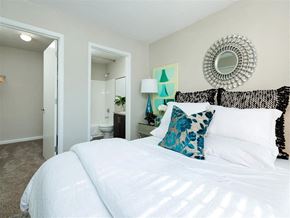Stockbridge apartment for rent - A bedroom with a large bed and a mirror on the wall.