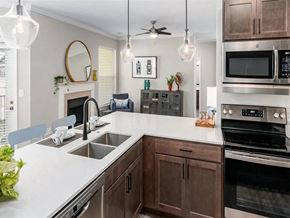 Granger apartment for rent - A modern kitchen with a white countertop and dark wood cabinets.