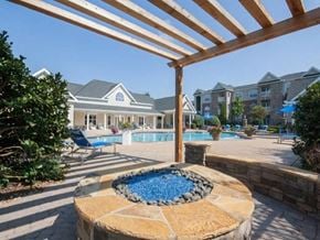 Stockbridge apartment for rent - A pool area with a hot tub and a pergola.