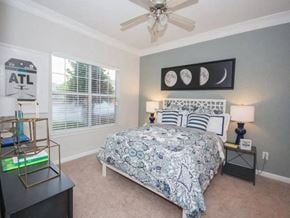 Stockbridge apartment for rent - A bedroom with a bed, nightstand, and a ceiling fan.