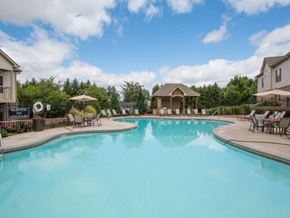 Mcdonough apartment for rent - A large swimming pool with a water slide and a gazebo in the background.