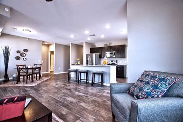 Goshen apartment for rent - A living room with a grey couch and a wooden coffee table.