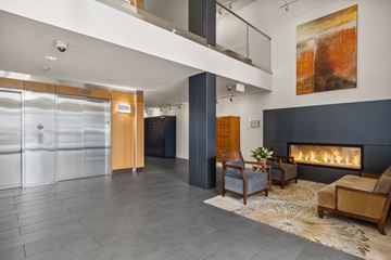 Everett apartment for rent - A modern living room with a fireplace and a painting on the wall.