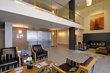 Everett apartment for rent - A modern living room with a fireplace and a painting on the wall.