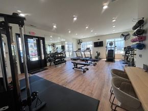 St. Peters apartment for rent - A gym with a variety of equipment including weights, machines, and a bench.