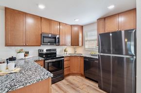 Chesterfield apartment for rent - A kitchen with wooden cabinets and a granite countertop.