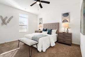 St. Peters apartment for rent - A bedroom with a bed, nightstand, and a ceiling fan.