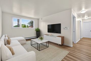 Halifax apartment for rent - A living room with a white couch and a black coffee table.