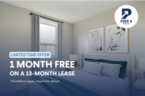 Kitchener apartment for rent - A bedroom with a bed, two lamps, and a framed picture on the wall.
