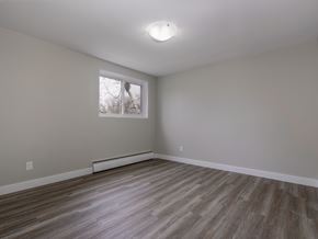 Kitchener apartment for rent - A room with a window and wooden flooring.