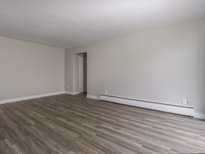 Kitchener apartment for rent - A room with a wooden floor and a door.