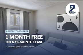 Moncton apartment for rent - A room with a couch and a poster advertising a free month on a lease.