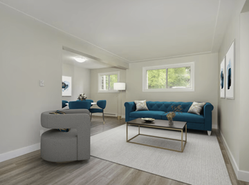 Hamilton apartment for rent - A living room with a blue couch and a grey ottoman.